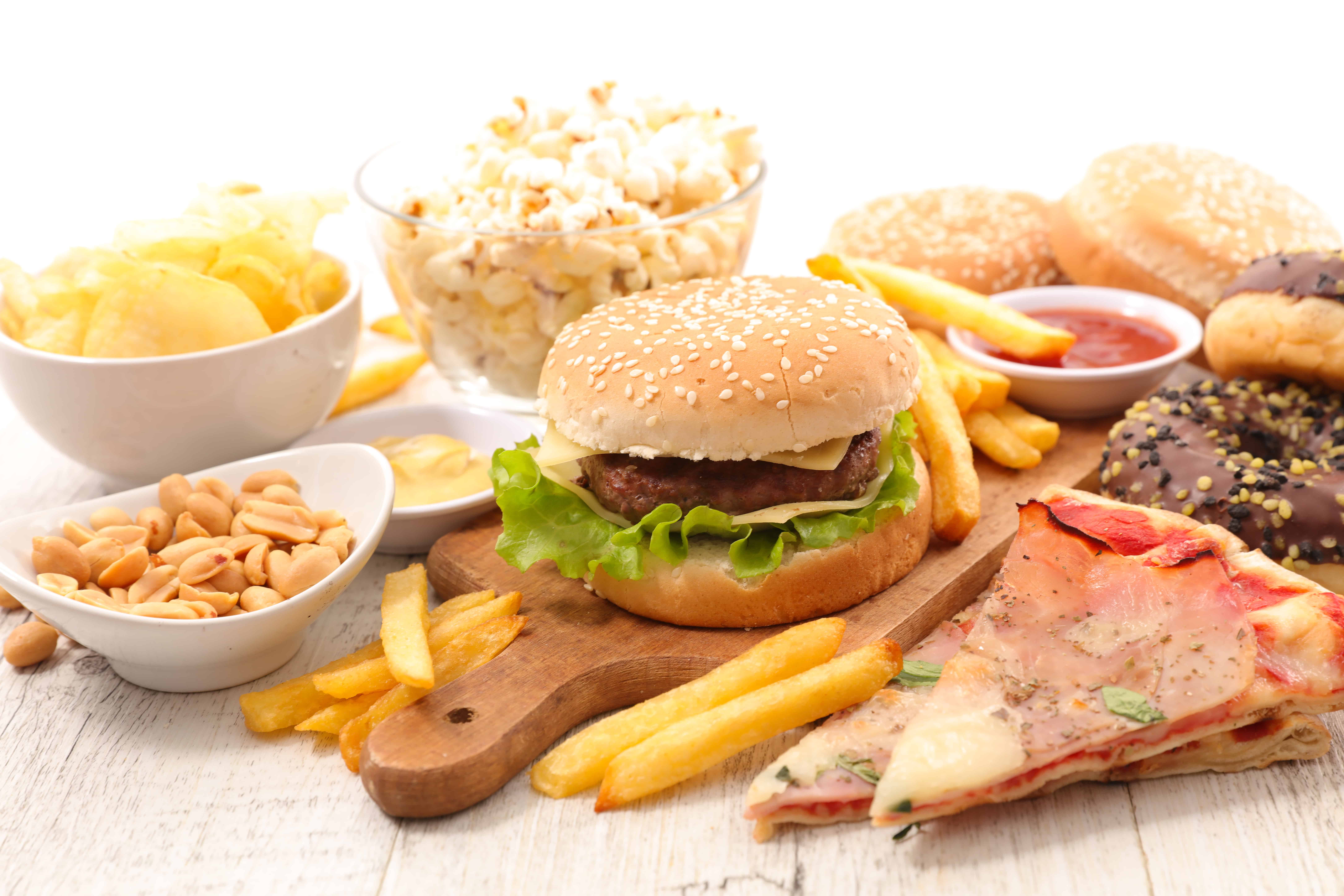 selection of high carbohydrate junk foods pizza chips burgers french fries