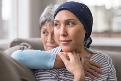mature-woman-in-her-60s-embraces-her-mid30s-daughter-who-has-cancer