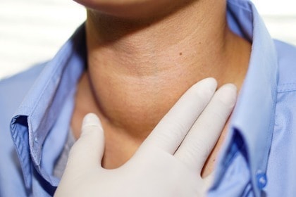 doctor examining patient with goiter: an abnormal enlargement of thyroid gland