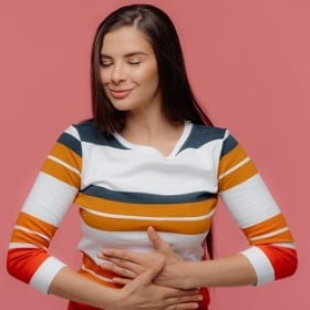 smiling-woman-holding-stomach