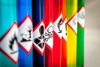 row of hazardous toxic chemicals with warning images