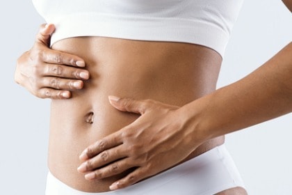 close-up-of-woman-with-her-hands-on-abdomen