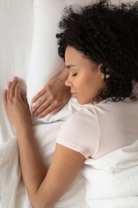 serene-woman-sleeping-in-comfortable-bed