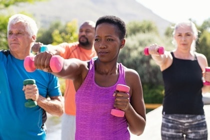 mature-group-of-people-exercising-with-dumbbells-outside