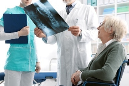 doctor-checking-a-senior-female-patients-xray-image