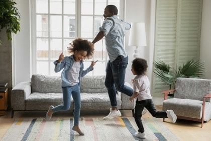 energetic-family-exercising-dancing-having-fun-in-livingroom