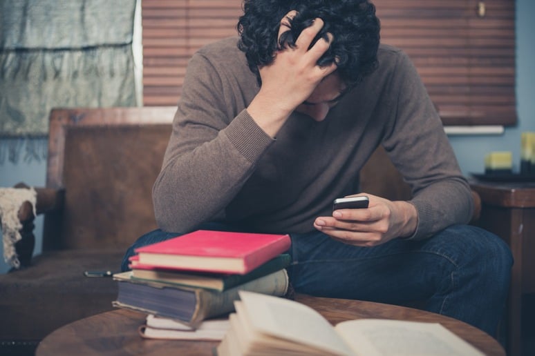 Man Stresses Looking at His Phone