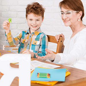 child working on letters with teacher