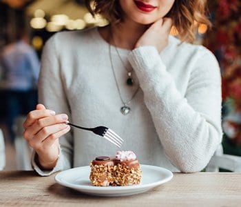 woman eating food with high glycemic index