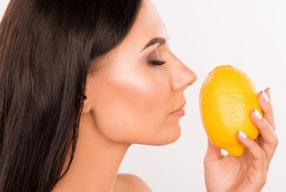 Inhaling scent of lemon zest which contains lemon essential oil
