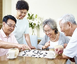 Family Playing Board Game at Kitchen Table