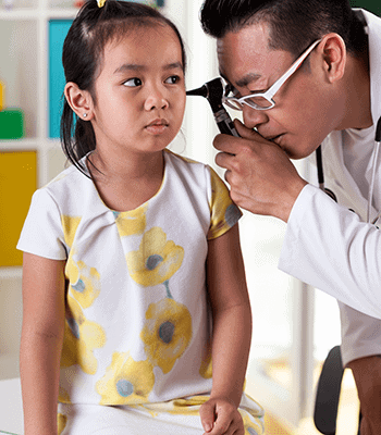 Child in a sundress Being Examined by a doctor