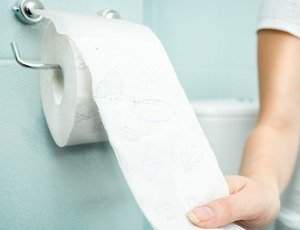 hand reaching for toilet paper