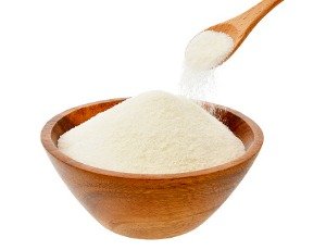 wooden bowl of collagen powder and spoon