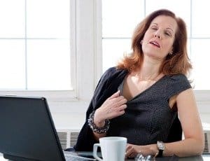 menopausal woman having hot flash at the office