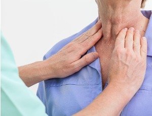 doctor examining woman's neck for goiter