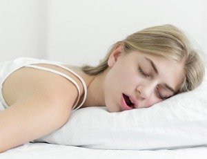 tired young woman sleeping with mouth open