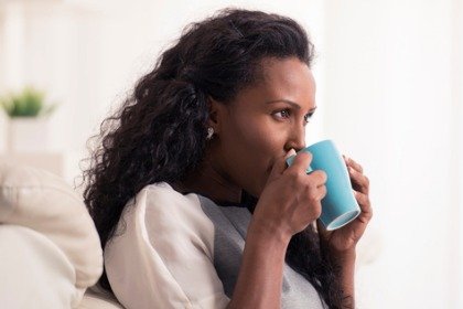 woman drinking from blue mug